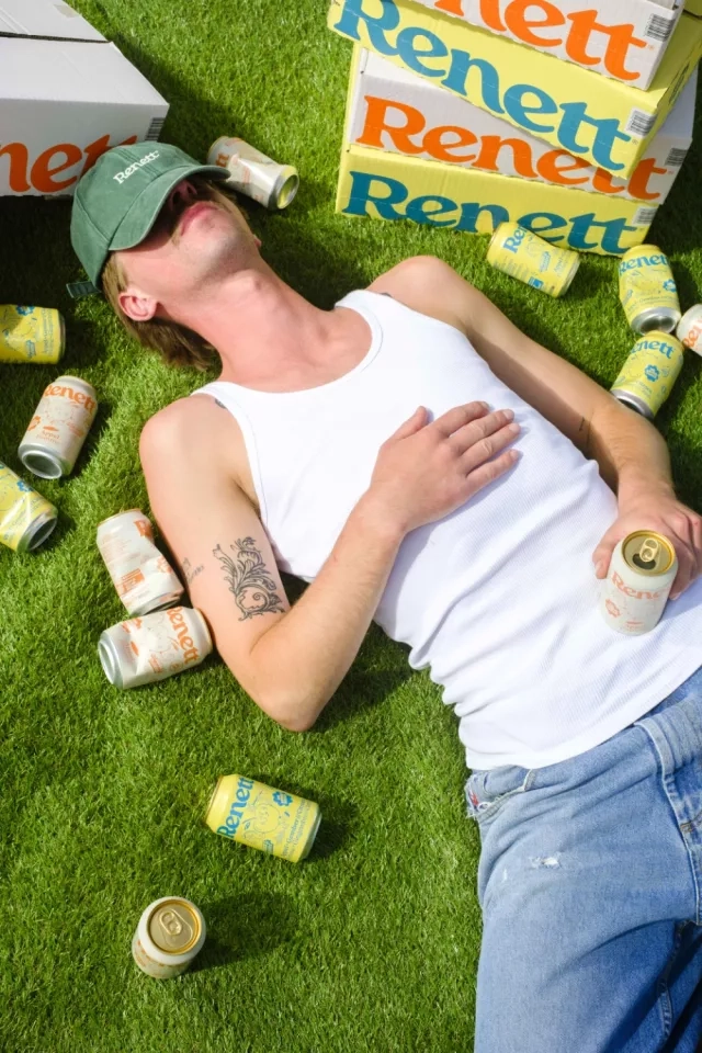 Man sleeping surounded with renett cans